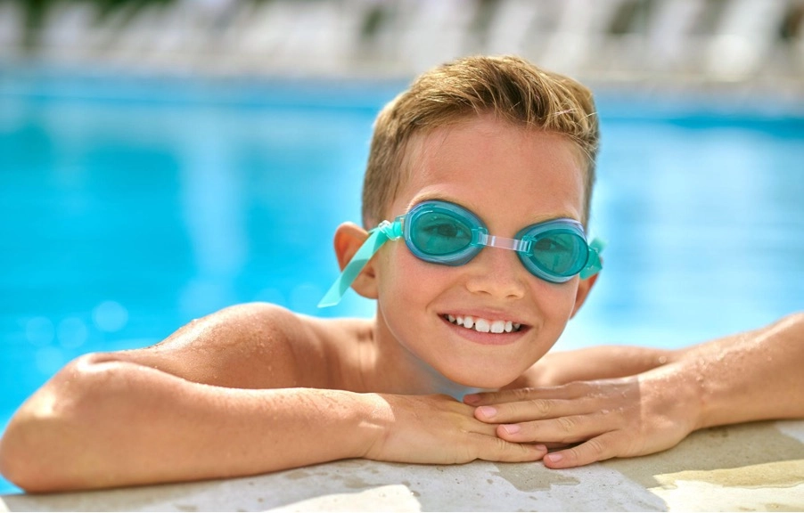 Boy in swimming goggles in pool