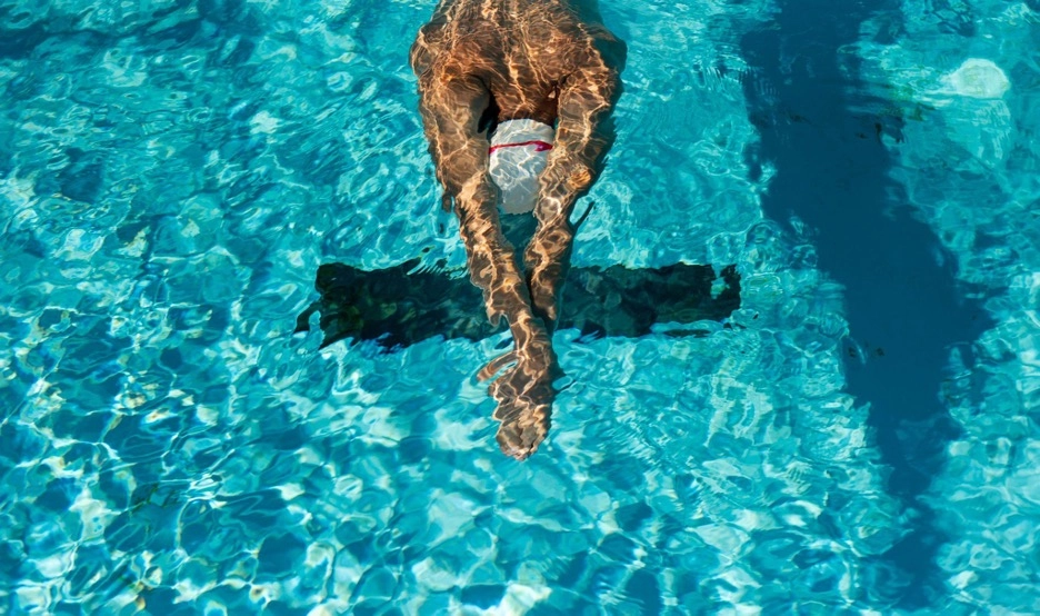 Underwater view of a swimmer diving a breaststroke in a pool