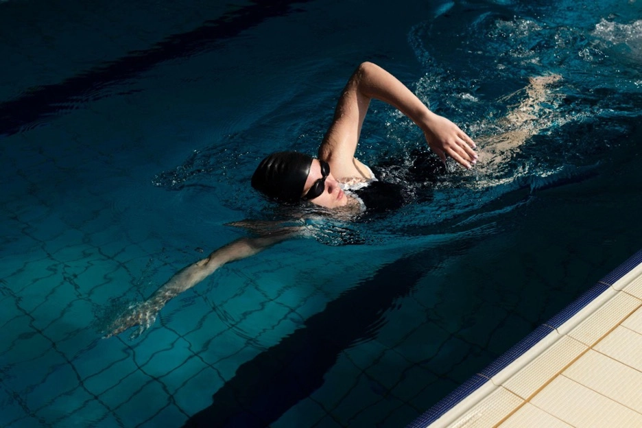 A woman swimming freestyle in a swimming pool