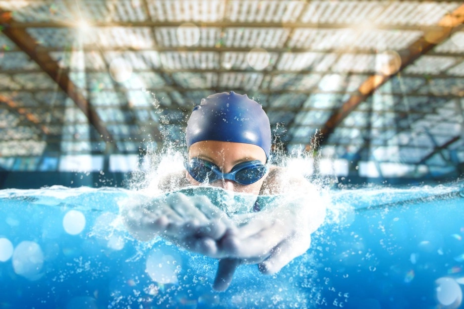Swimmer doing butterfly stroke in the indoor pool.
