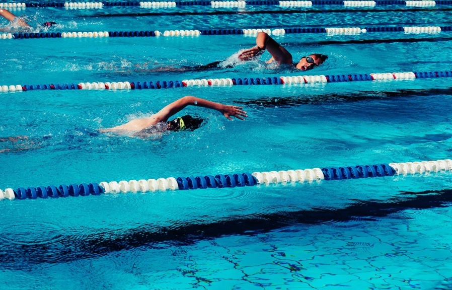 Swimmers in the pool with goggles on