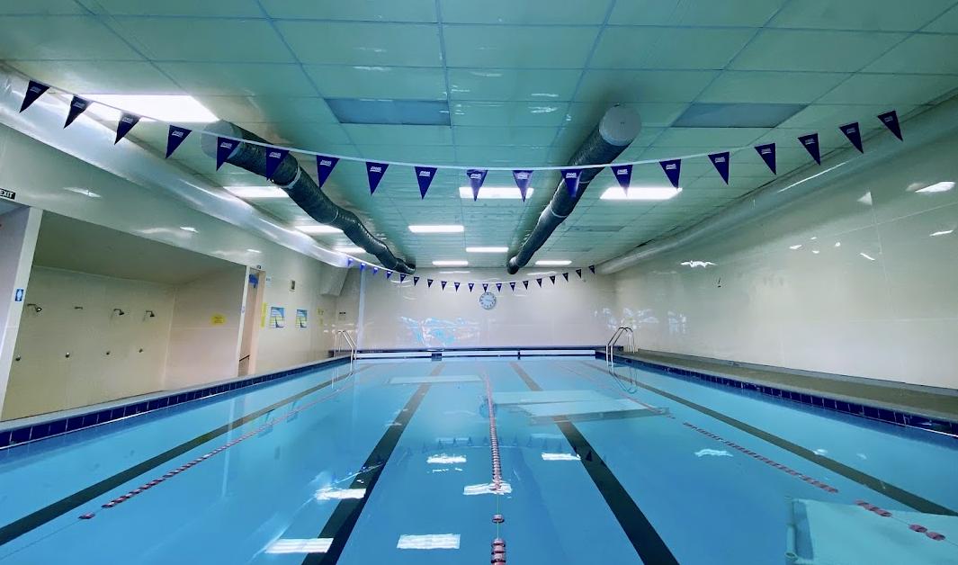 Swimmer doing butterfly stroke in the indoor pool.